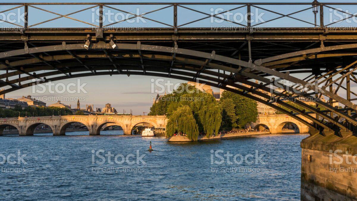 View of the city of Paris and the iron bridge over the Seine river in France.