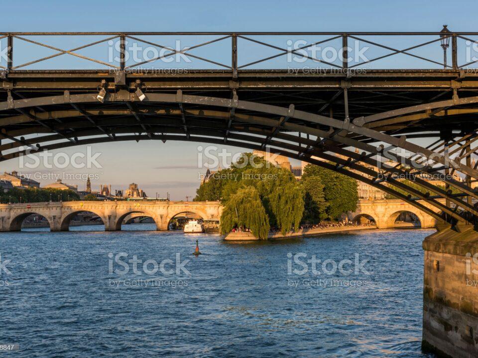 View of the city of Paris and the iron bridge over the Seine river in France.
